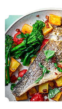 Bright and colourful meal with vegetables and sea bream. Tenderstem broccoli and diced chorizo